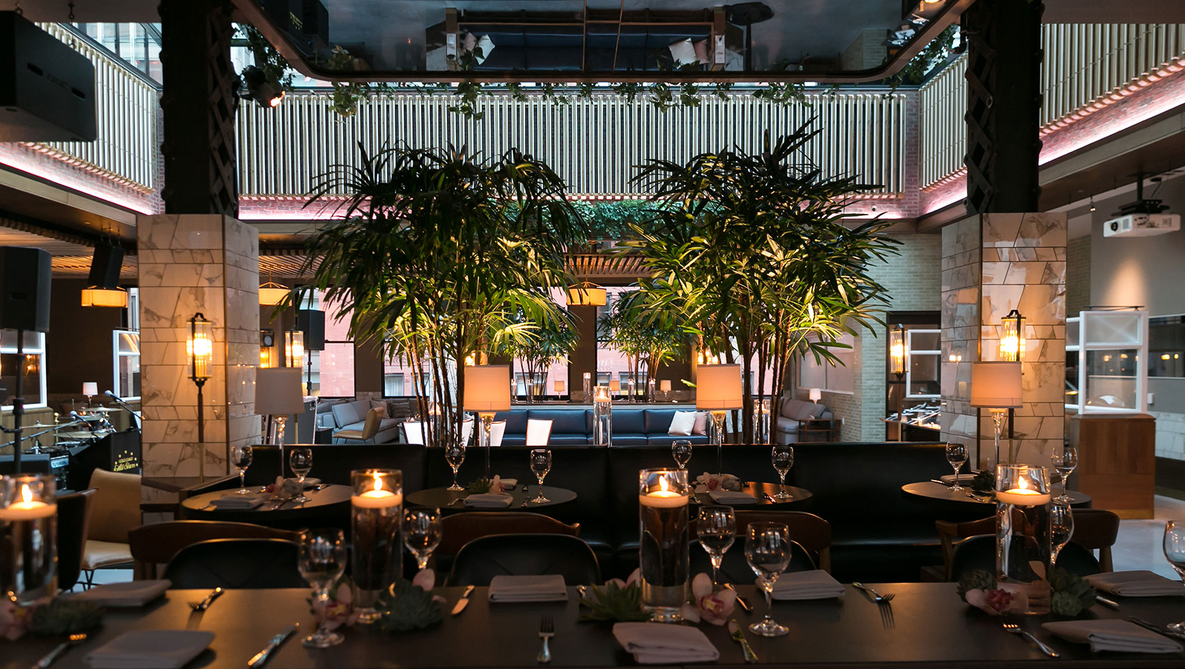 rooftop dining setup with candles and foliage